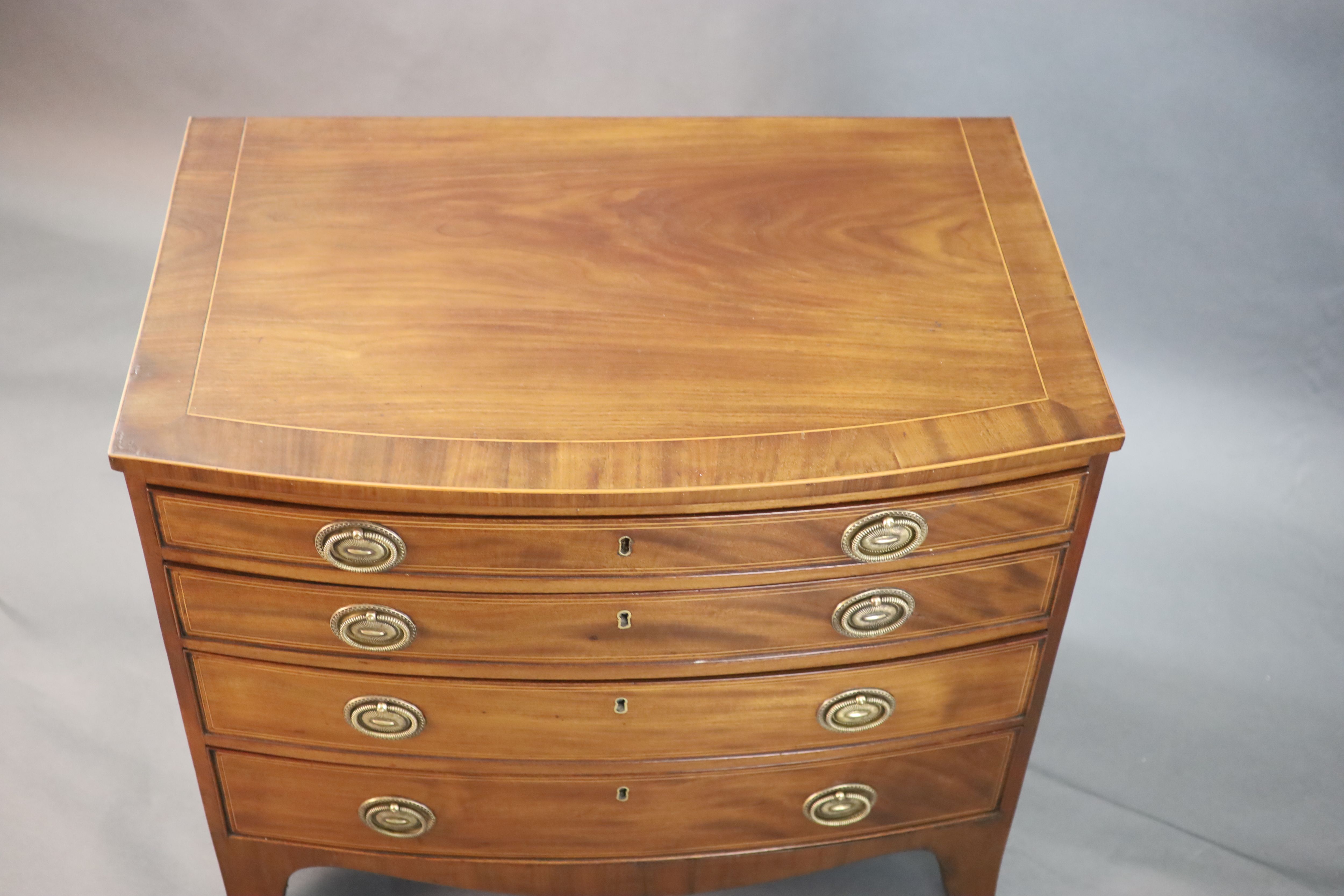 A Regency crossbanded mahogany bowfront chest, W.2ft 10in. D.1ft 10in. H.2ft 6in.